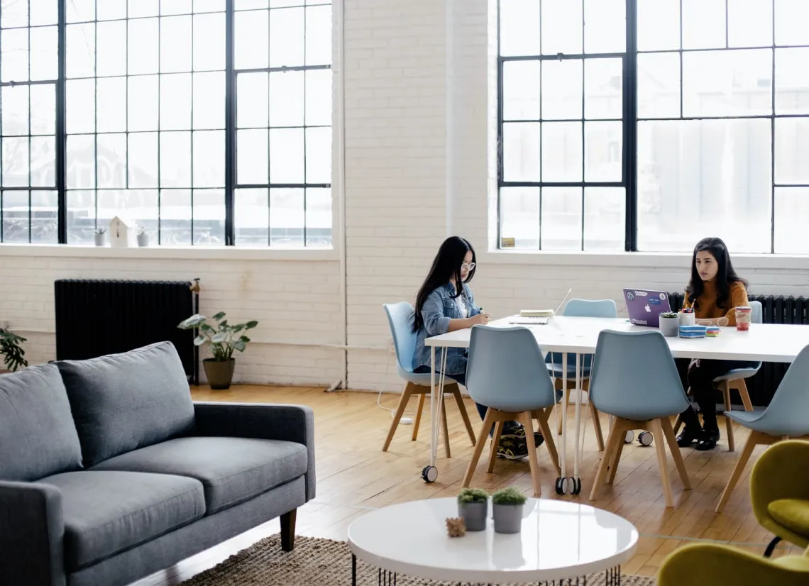 Image of two Team Members working at a table